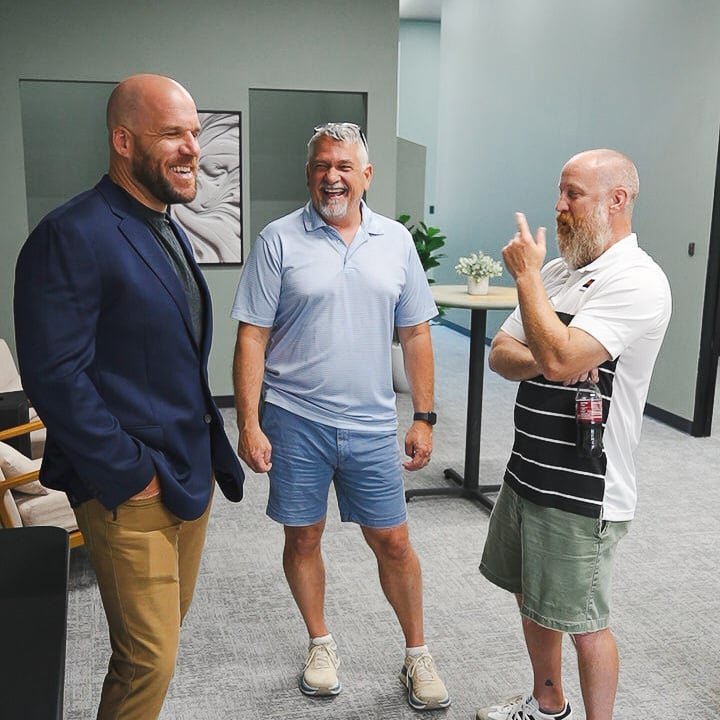 Business owners talking and laughing in the Avenue 118 common area